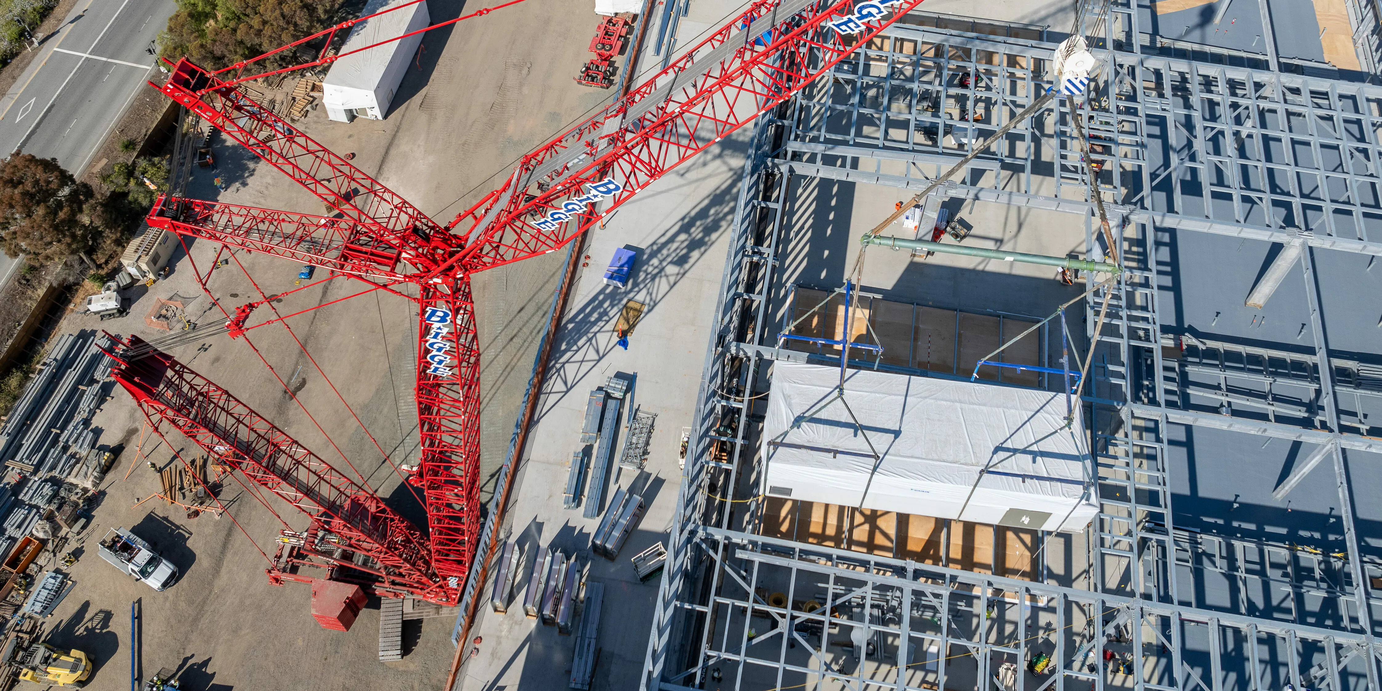 Aerial view of a Bigge crawler crane on a jobsite at dawn